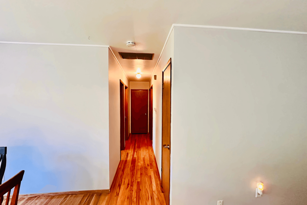 Bright, accessible hallway leading to private resident rooms.
